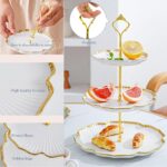 Elegant BPFY 3-tier porcelain serving tray with gold trim and embossed floral design, holding cupcakes and pastries.