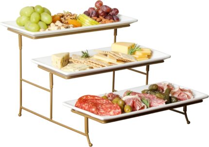 Three-tier serving set with white rectangular plates and a gold metal stand, displaying various snacks.