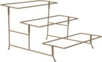 Three-tier serving set with white rectangular plates and a gold metal stand, displaying various snacks.