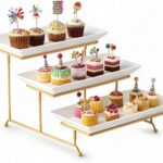 A three-tier Gomakren serving stand with gold frame and white rectangular porcelain platters, displaying various desserts.