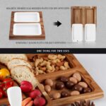 A large hecef acacia wood charcuterie board set with cheese, crackers, and fruit, showing the pull-out drawers and knife set.