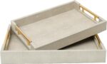 Two rectangular ivory faux shagreen serving trays with brushed gold handles, one larger and one smaller, stacked slightly.