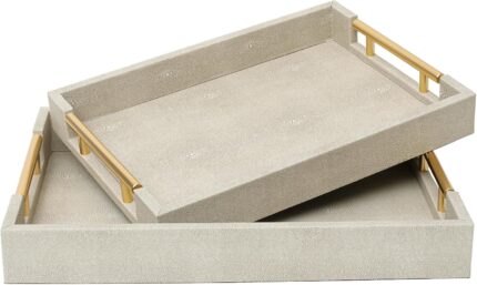 Two rectangular ivory faux shagreen serving trays with brushed gold handles, one larger and one smaller, stacked slightly.