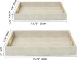 Two rectangular ivory faux shagreen serving trays with brushed gold handles, one larger and one smaller, stacked slightly.