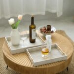 Two rectangular ivory faux shagreen serving trays with brushed gold handles, one larger and one smaller, stacked slightly.