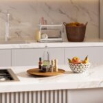 An 18-inch round Tidita acacia wood lazy susan turntable on a kitchen countertop, showcasing its natural wood grain.