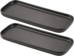 Two black rectangular ceramic trays by VanEnjoy, ideal for organizing soap bottles and toiletries on a bathroom or kitchen co
