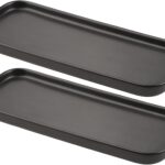 Two black rectangular ceramic trays by VanEnjoy, ideal for organizing soap bottles and toiletries on a bathroom or kitchen co