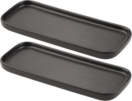 Two black rectangular ceramic trays by VanEnjoy, ideal for organizing soap bottles and toiletries on a bathroom or kitchen co
