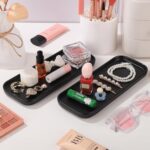 Two black rectangular ceramic trays by VanEnjoy, ideal for organizing soap bottles and toiletries on a bathroom or kitchen co