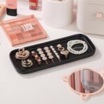 Two black rectangular ceramic trays by VanEnjoy, ideal for organizing soap bottles and toiletries on a bathroom or kitchen co
