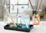 A sleek, small black rectangular plastic tray from VCREATC, ideal for organizing soaps or vanity items on a countertop.