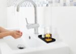 A sleek, small black rectangular plastic tray from VCREATC, ideal for organizing soaps or vanity items on a countertop.